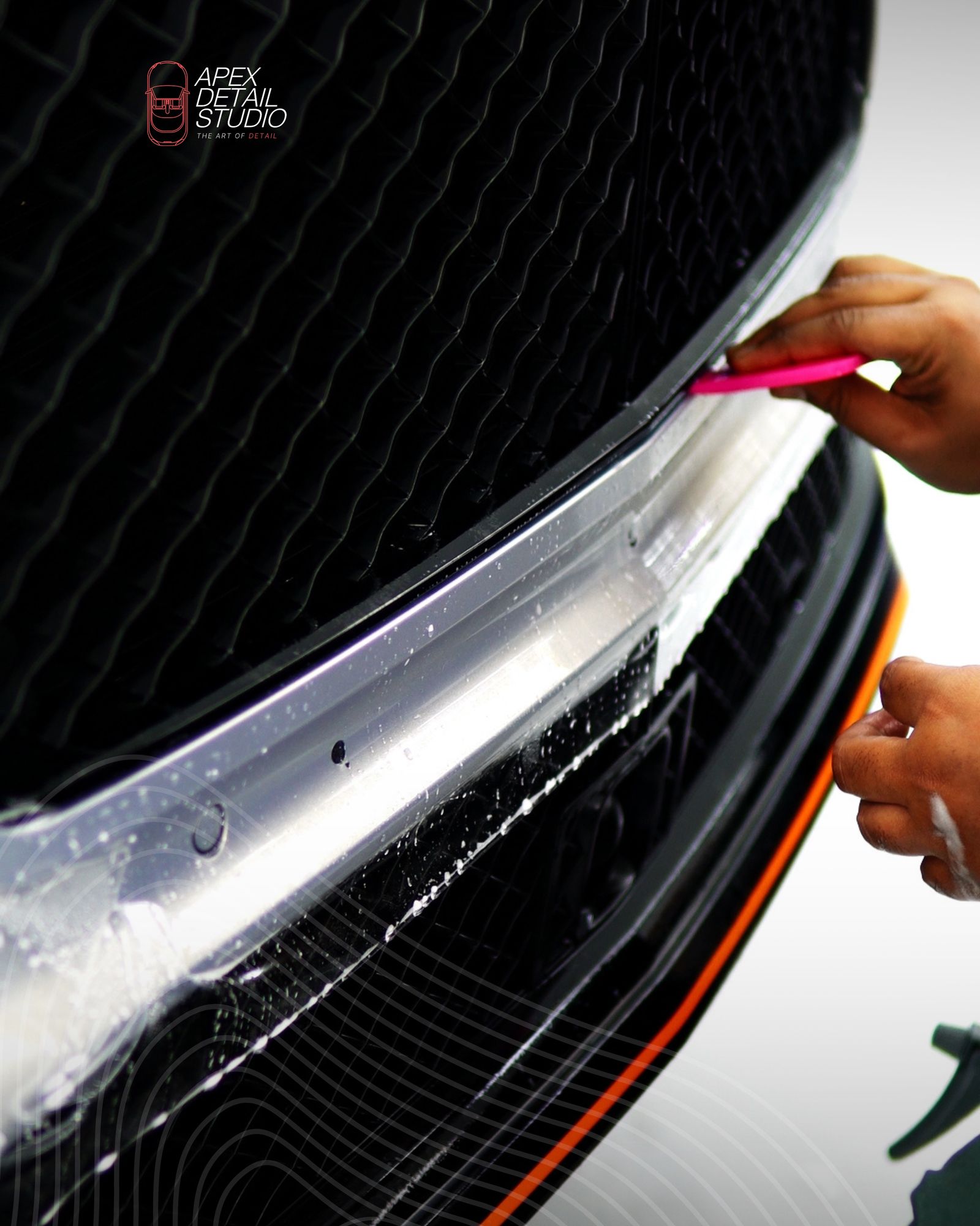 Installer applying paint protection film to a Bentley front bumper at Apex Detail Studio Dubai