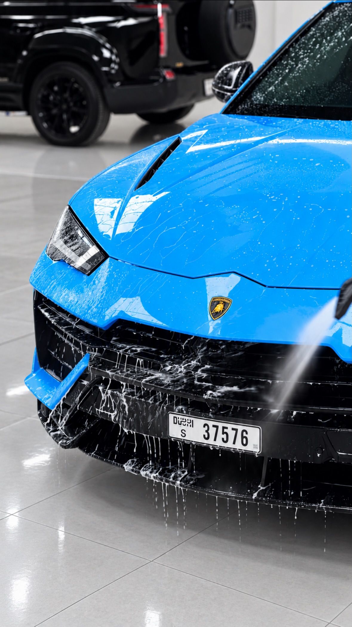 Blue Lamborghini Urus being foam washed at Apex Detail Studio Dubai