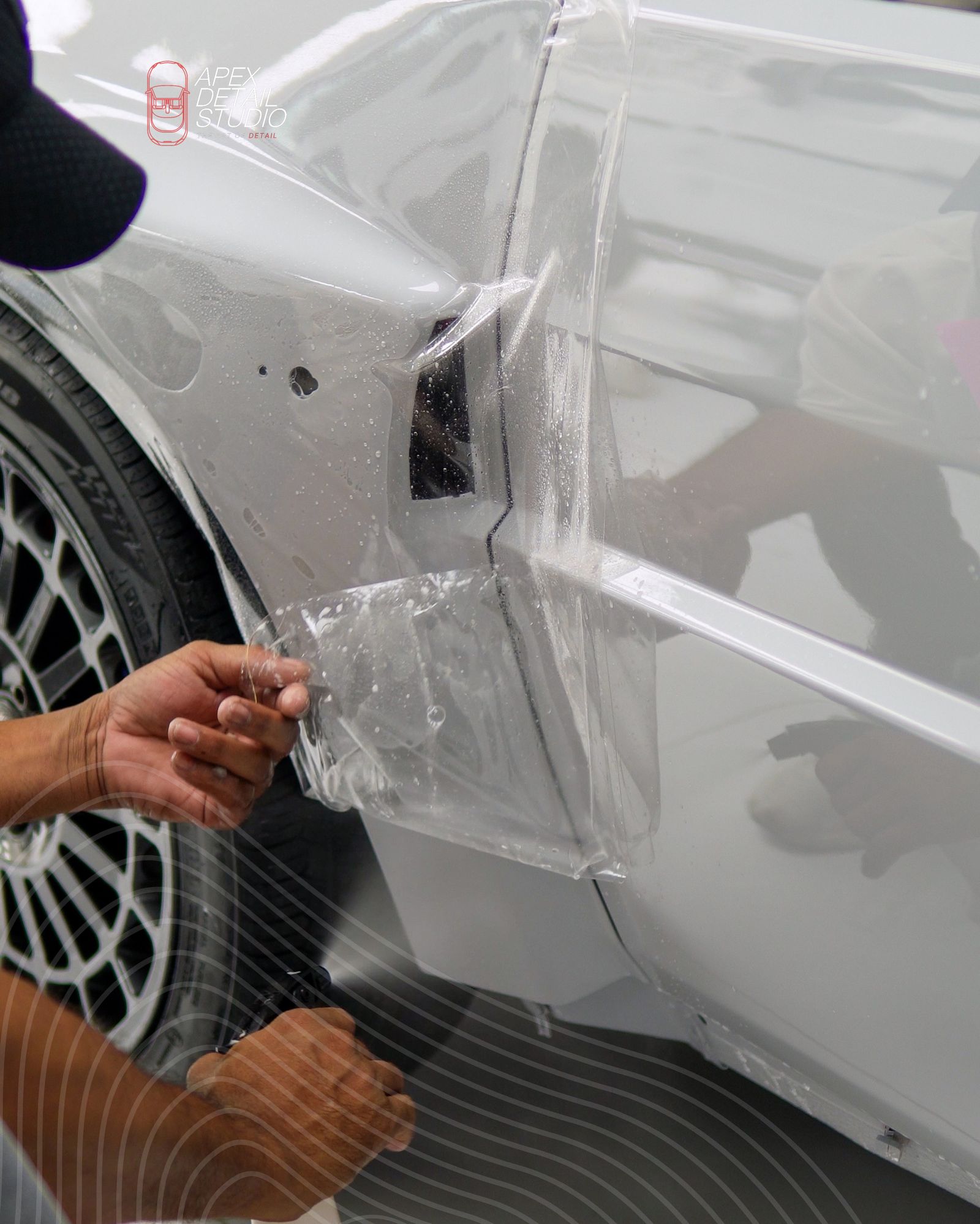 Detailer working on the wheel arch of a Lancia at Apex Detail Studio Dubai