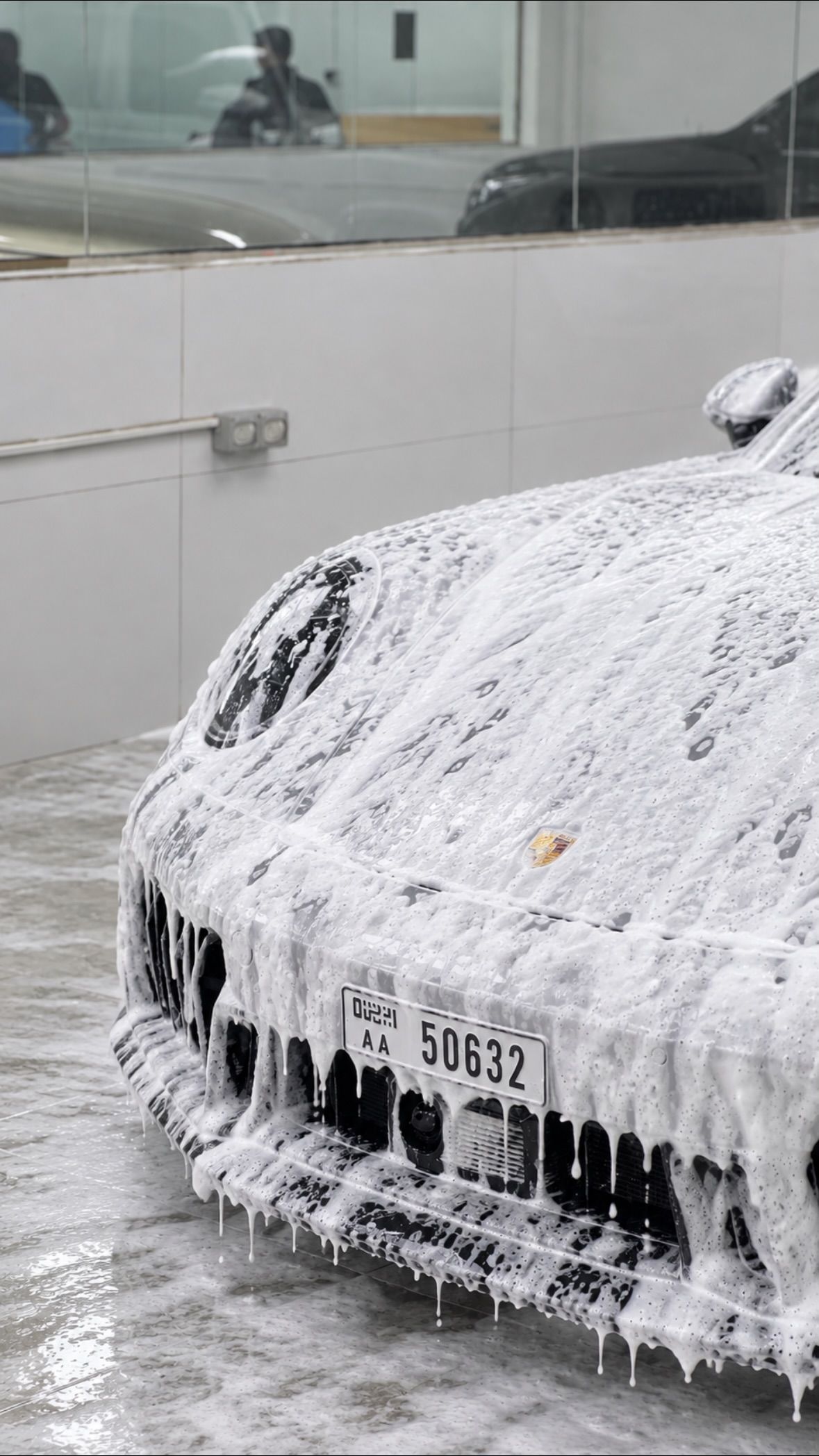 Silver Porsche being foam washed at Apex Detail Studio Dubai
