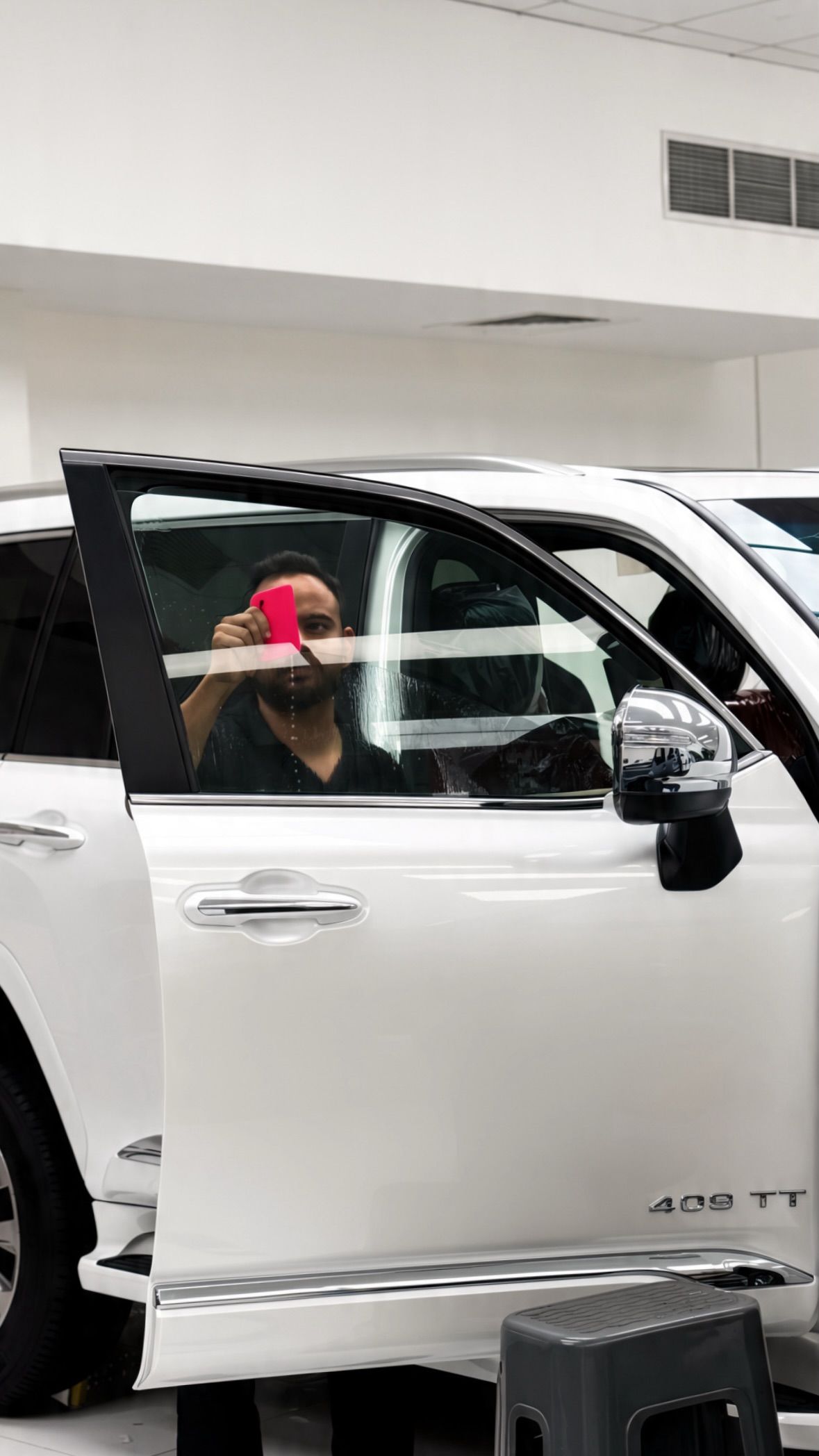 White SUV with door open being detailed at Apex Detail Studio Dubai