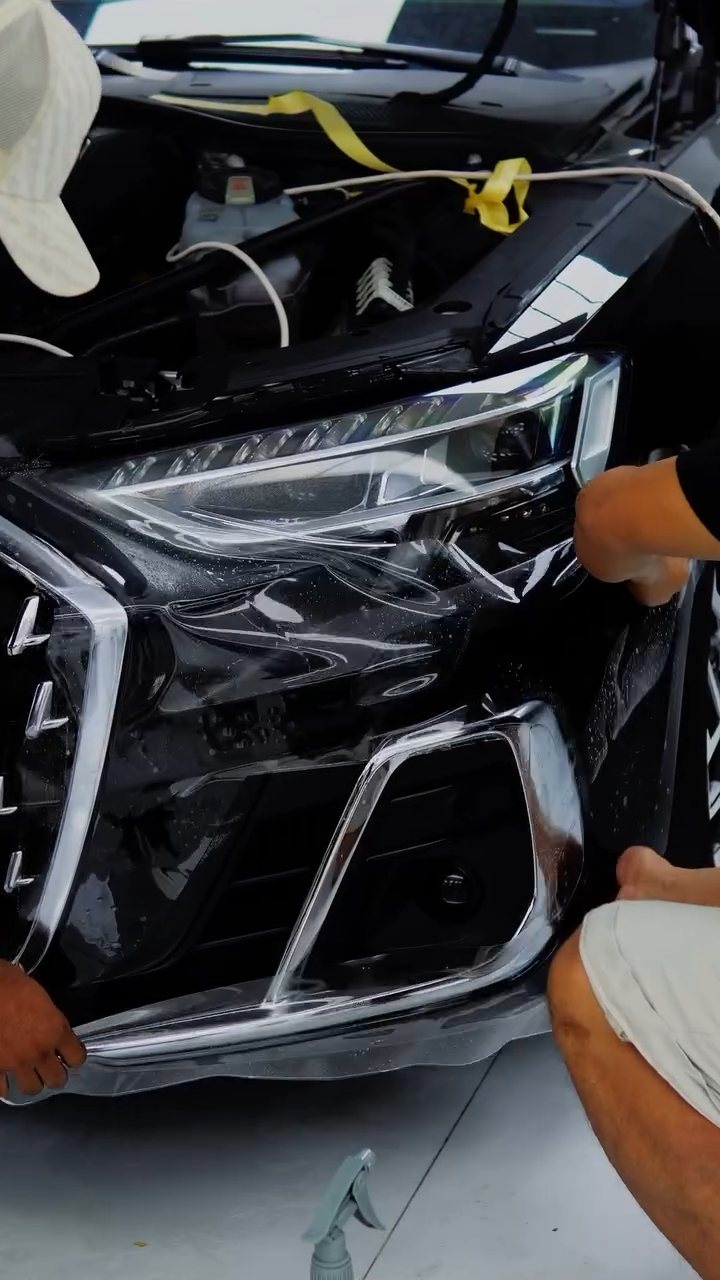 PPF being fitted to the Audi A8 L front bumper and headlight at Apex Detail Studio