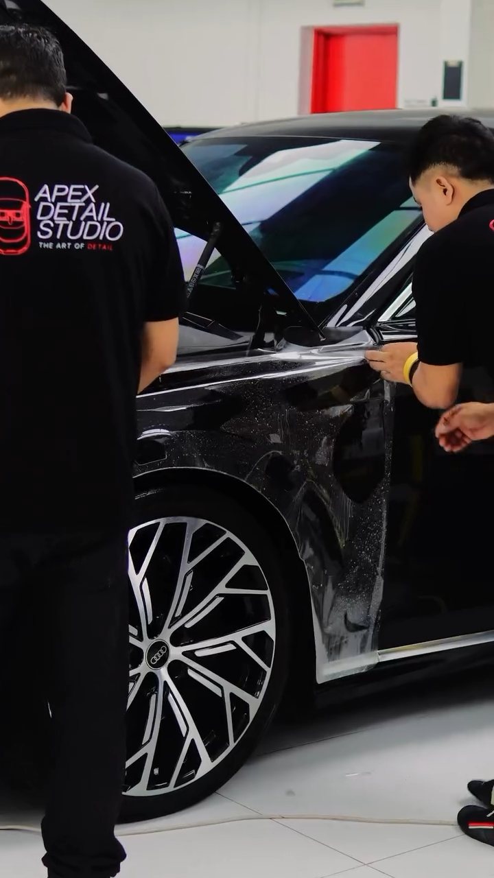 Apex team fitting PPF along the black Audi A8 L side in Dubai
