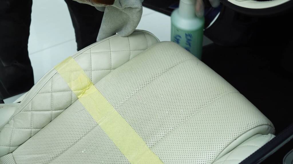 Applying pH balanced leather cleaner to a Bentley seat