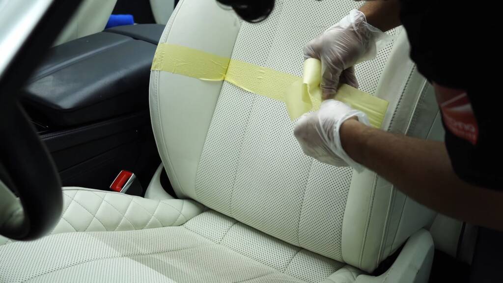 Wiping cleaner off Bentley cream leather