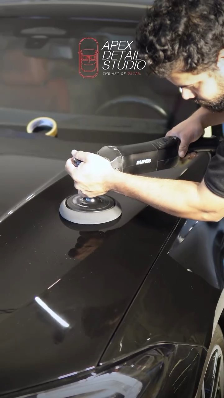 Detailer machine polishing the black BMW bonnet before ceramic coating in Dubai