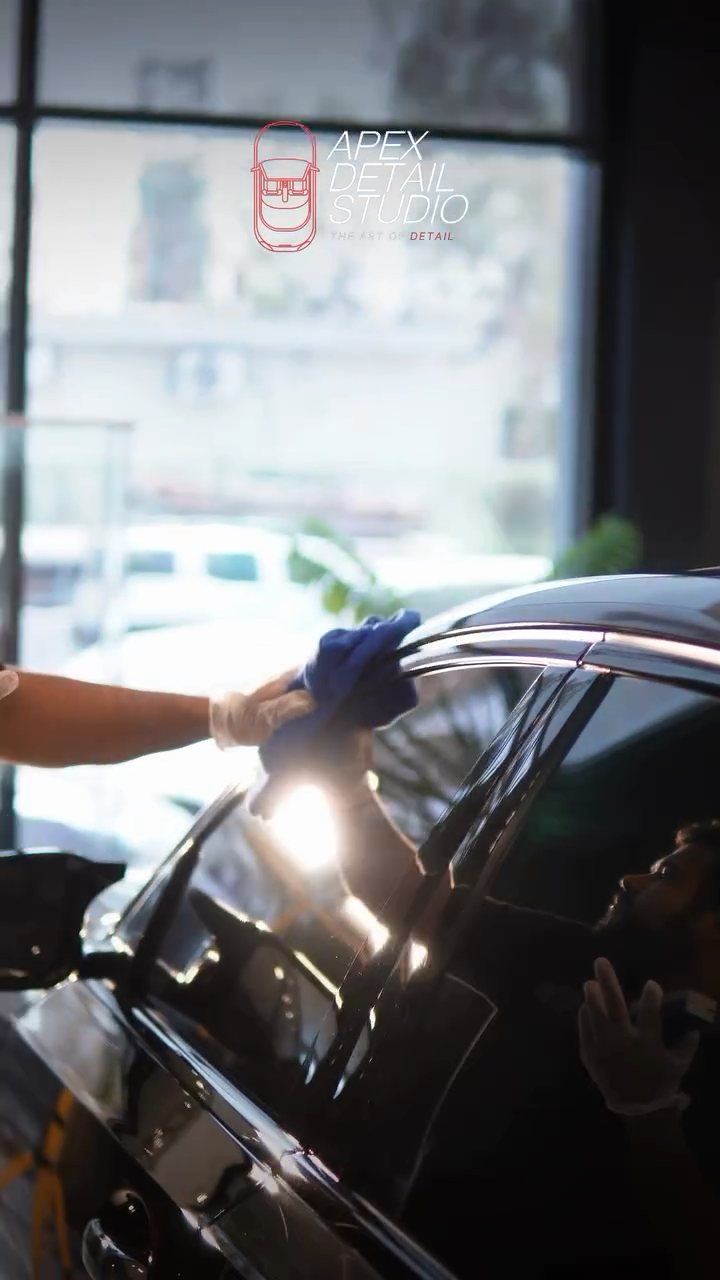 Buffing the coating on the BMW pillar with a microfibre towel in Dubai
