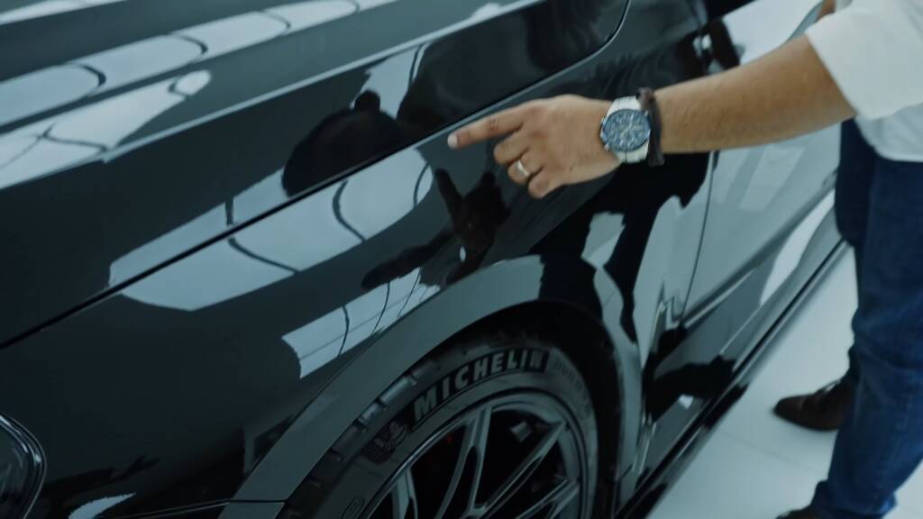 Pointing out a lifting PPF edge on a BMW M2 door