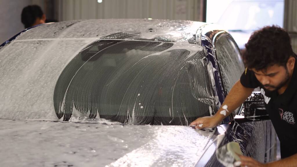 Detailer preparing the bonnet edge of a BMW M2 CS