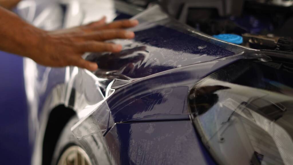 PPF being laid on the boot lid of a BMW M2 CS
