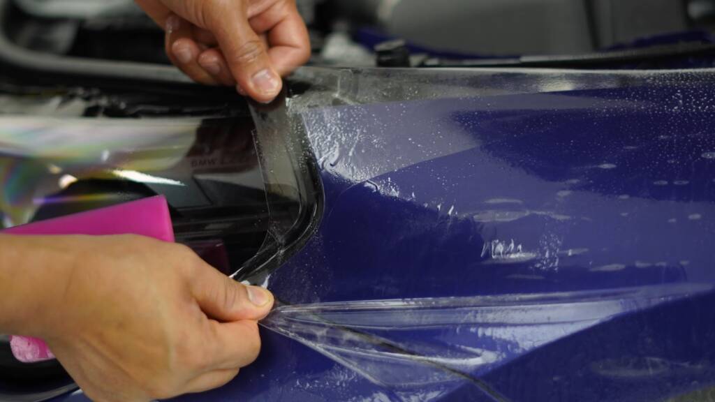 PPF being trimmed around the tail light of a BMW M2 CS