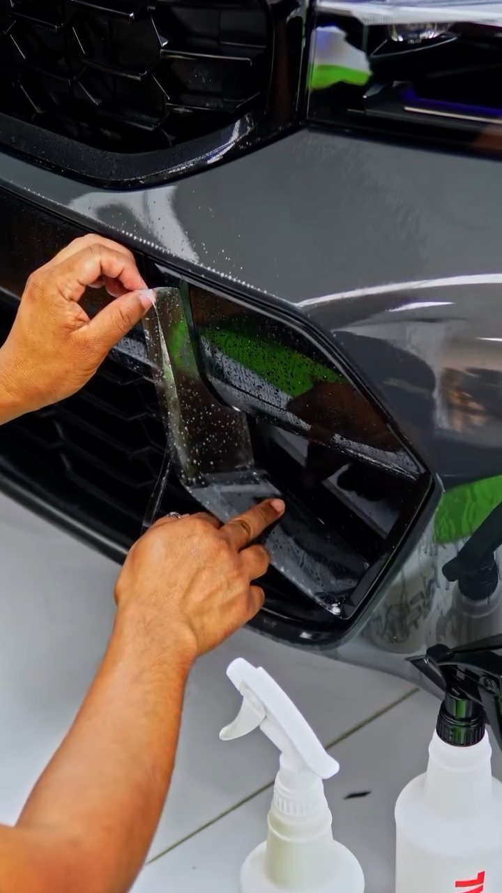 Installer fitting PPF to the BMW M340i front grille surround with slip solution