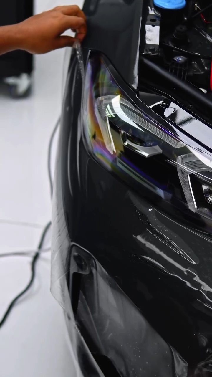 PPF being fitted over the BMW M340i headlight in Dubai