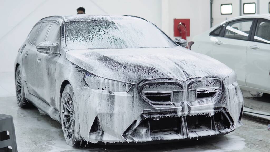 Matte grey BMW M5 Touring covered in snow foam during the pre-PPF wash at Apex Detail Studio Dubai