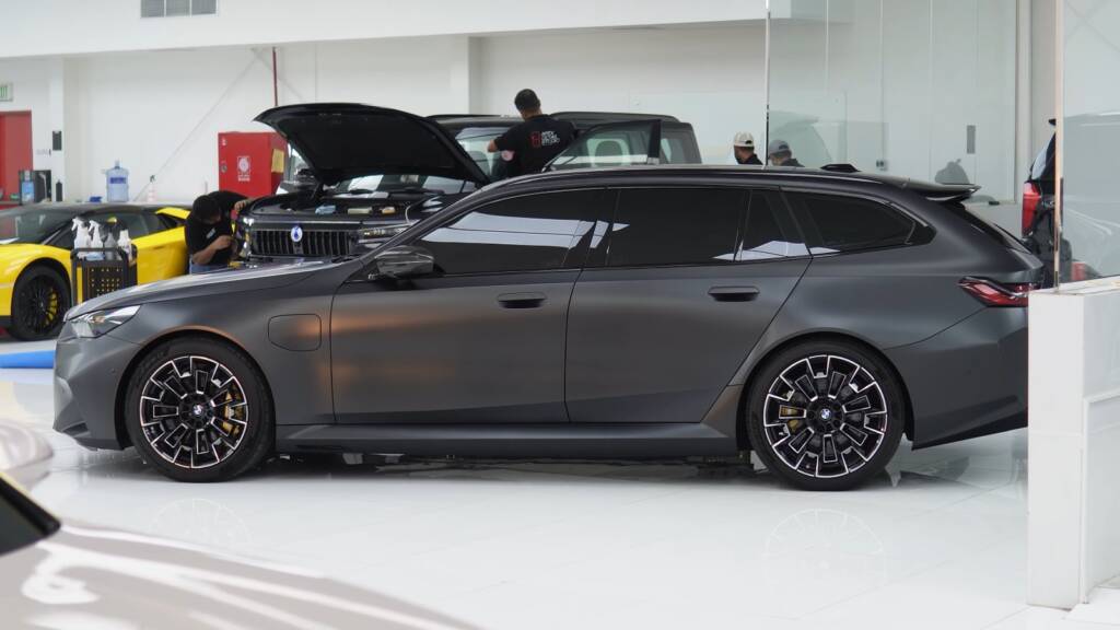 Side profile of a matte grey BMW M5 Touring after full matte PPF at Apex Detail Studio Dubai