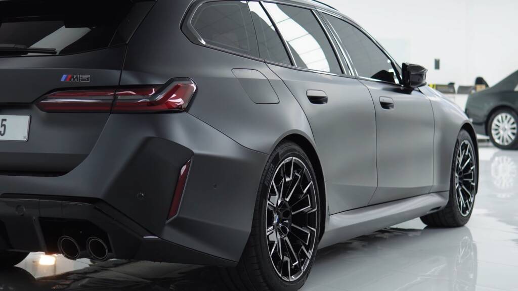 Rear three-quarter view of a matte grey BMW M5 Touring with full matte PPF in Dubai