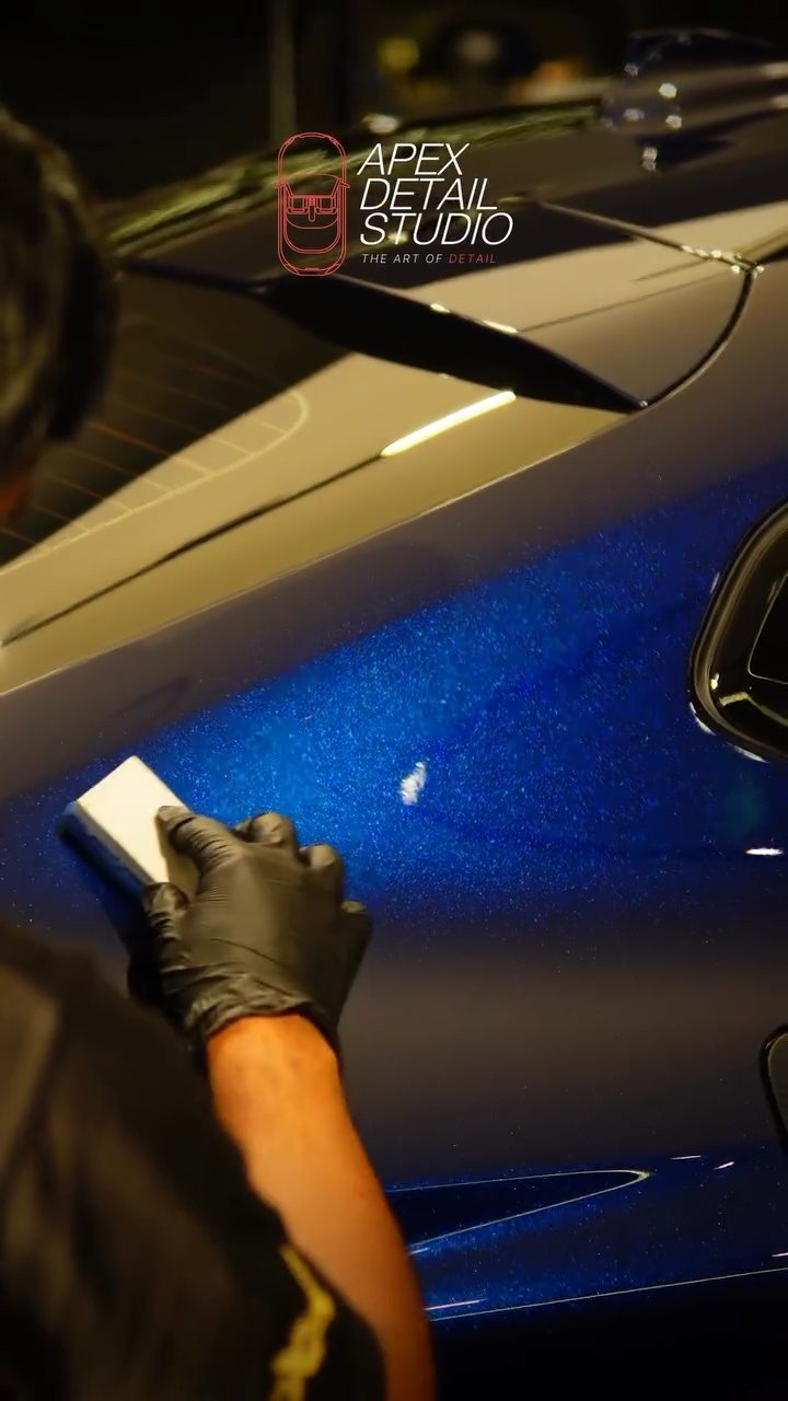 Close-up of ceramic coating going onto the BMW X4 metallic blue paint