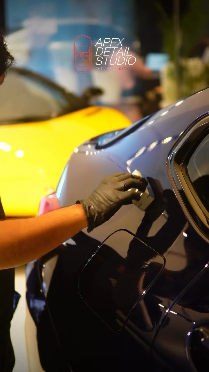 Applying ceramic coating to the BMW X4 rear door in Dubai