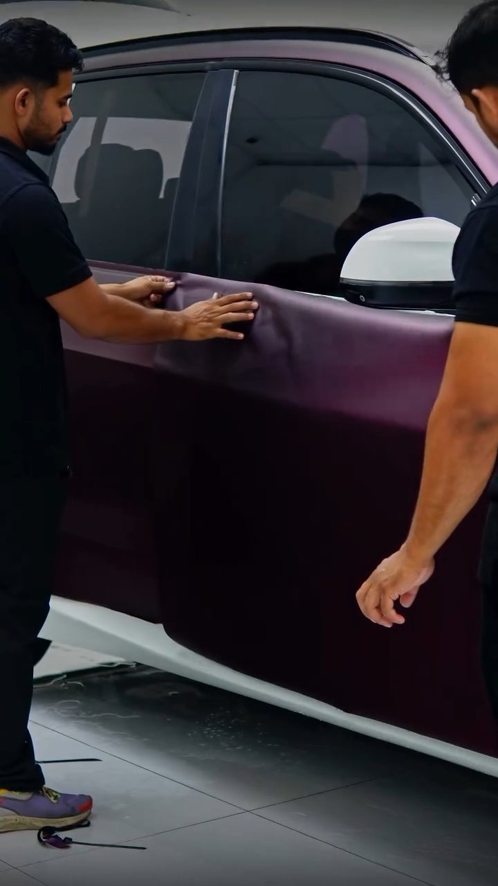 Apex installers fitting purple colour PPF to the BMW X5 doors in Dubai