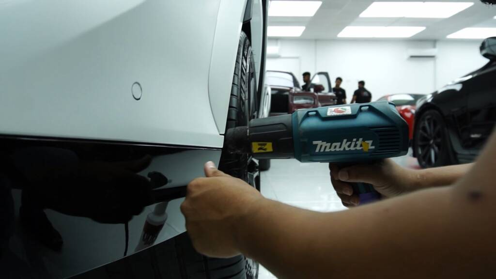 Machine polishing on the 2024 BMW X6 M Competition during the PPF job at Apex Detail Studio Dubai