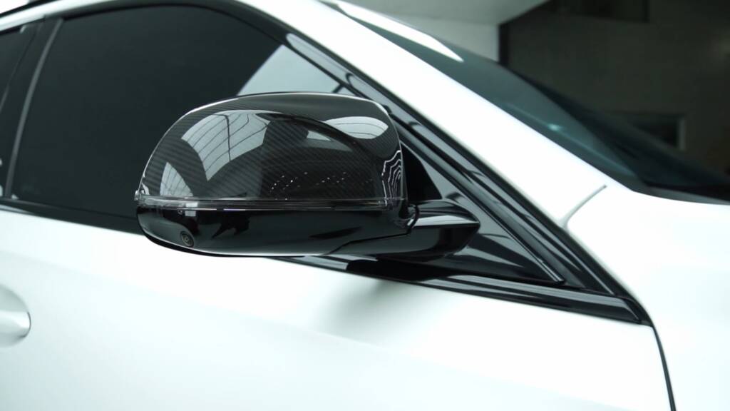 2024 BMW X6 M Competition gloss black mirror cap next to satin white paint at Apex Detail Studio Dubai