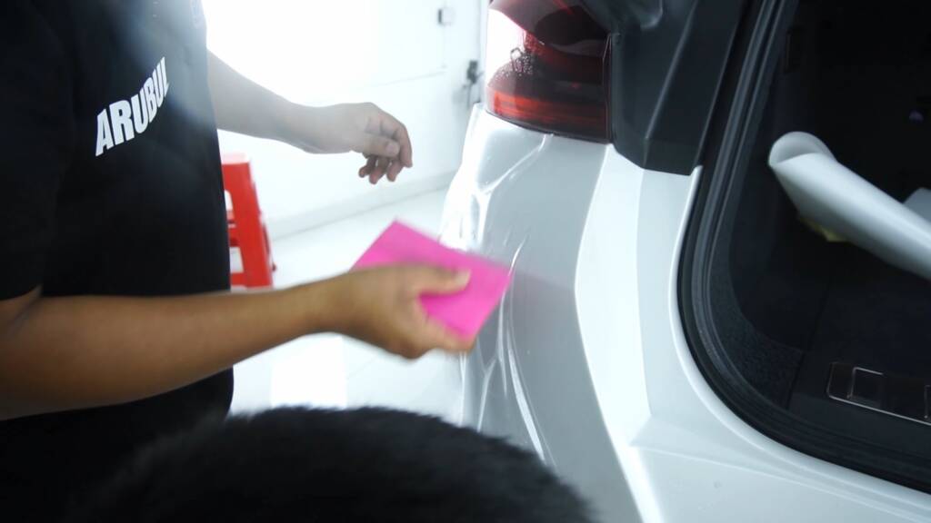 Squeegee work on the 2024 BMW X6 M Competition rear door and quarter at Apex Detail Studio Dubai
