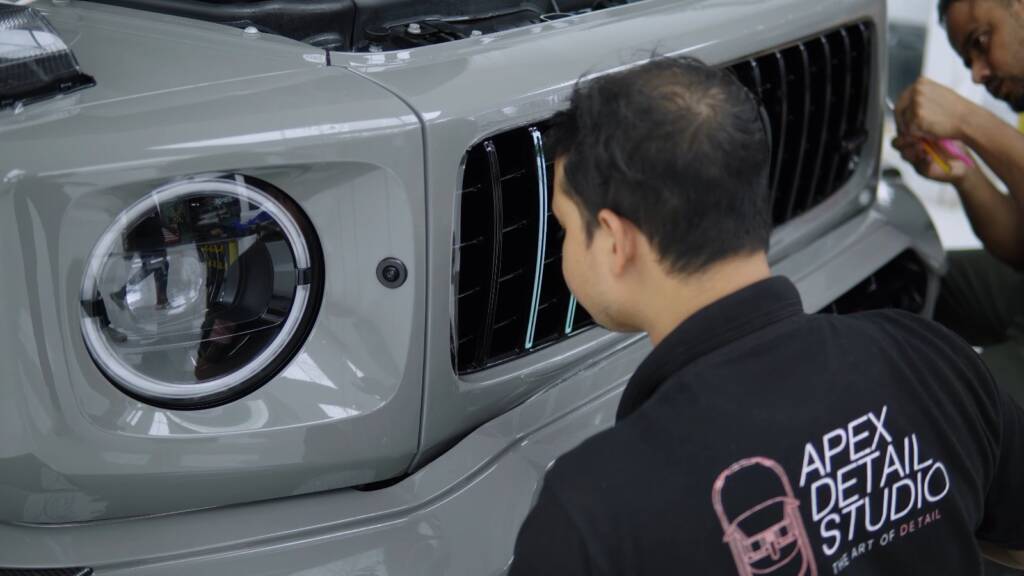 Installer fitting PPF around the headlight of a Brabus G800, Dubai