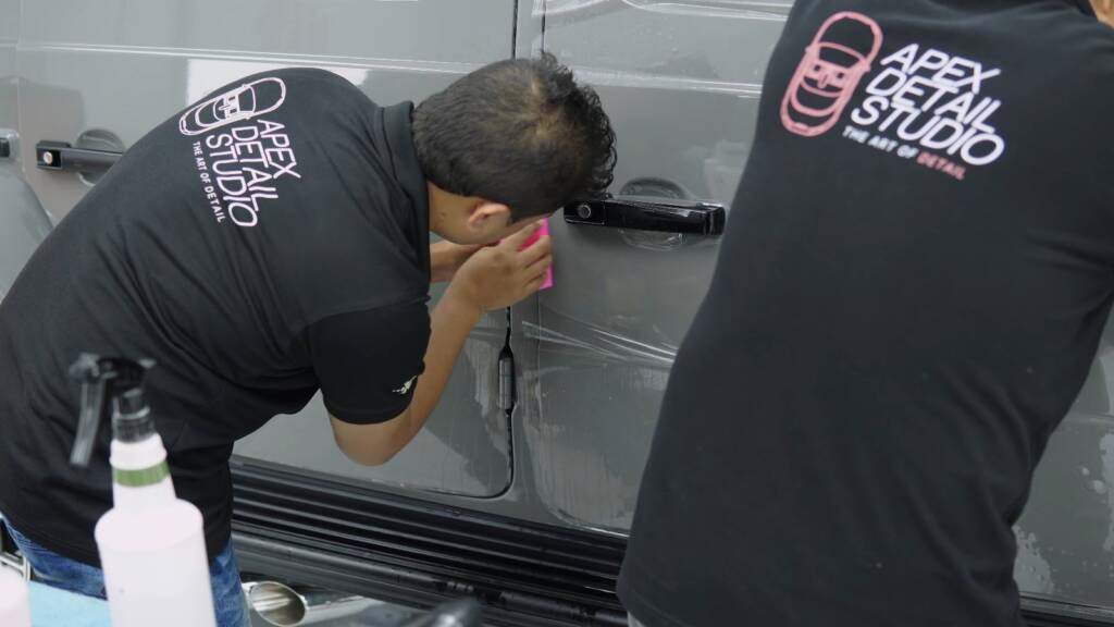 Installer squeegeeing PPF on the lower door of a Brabus G800 in Dubai