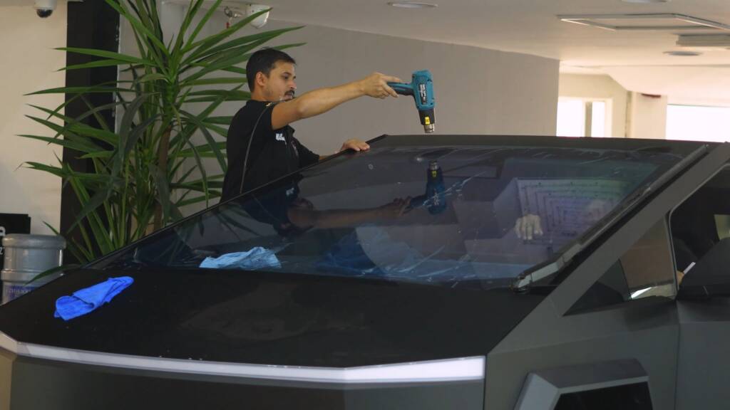 Heat shaping window tint film on Tesla Cybertruck glass in Dubai