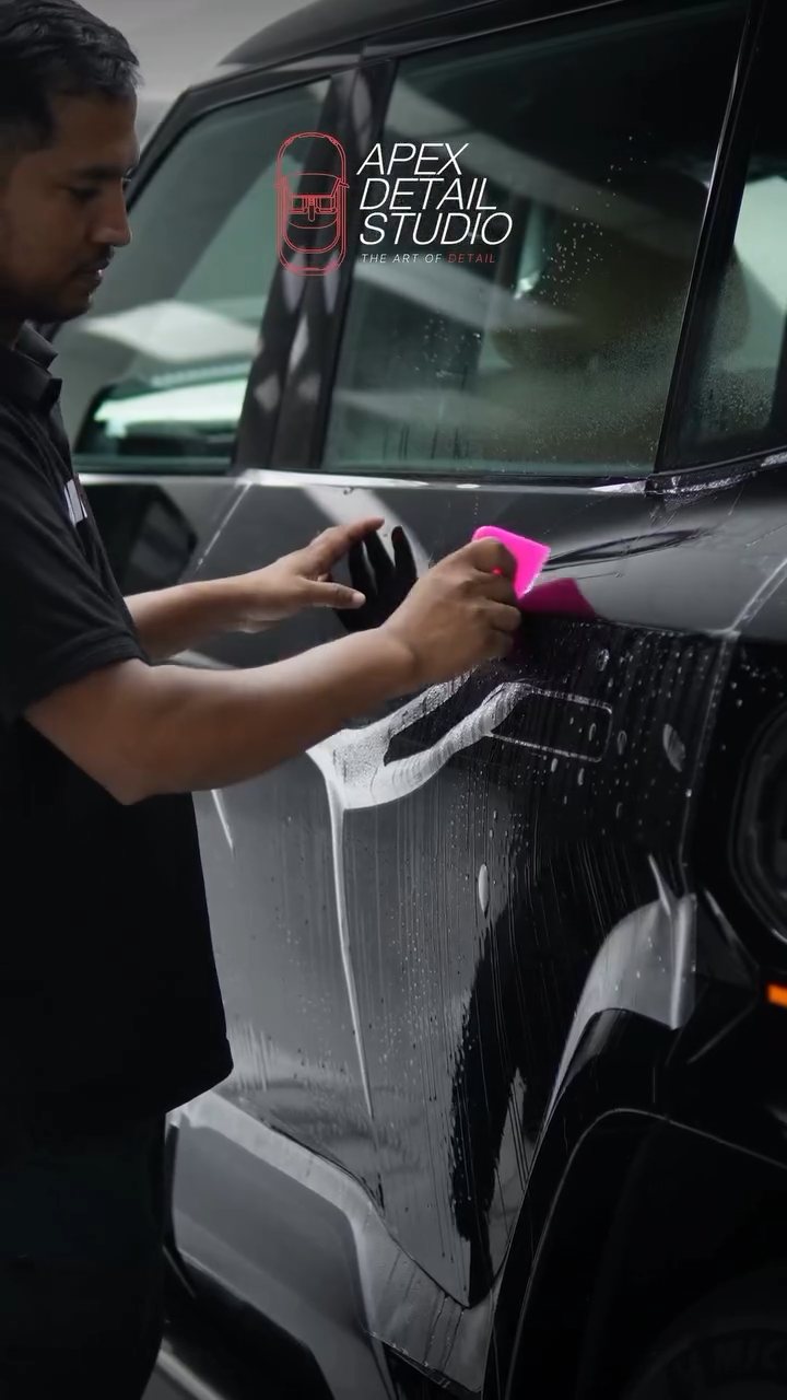 Squeegeeing PPF on the Denza B8 door at Apex Detail Studio Dubai