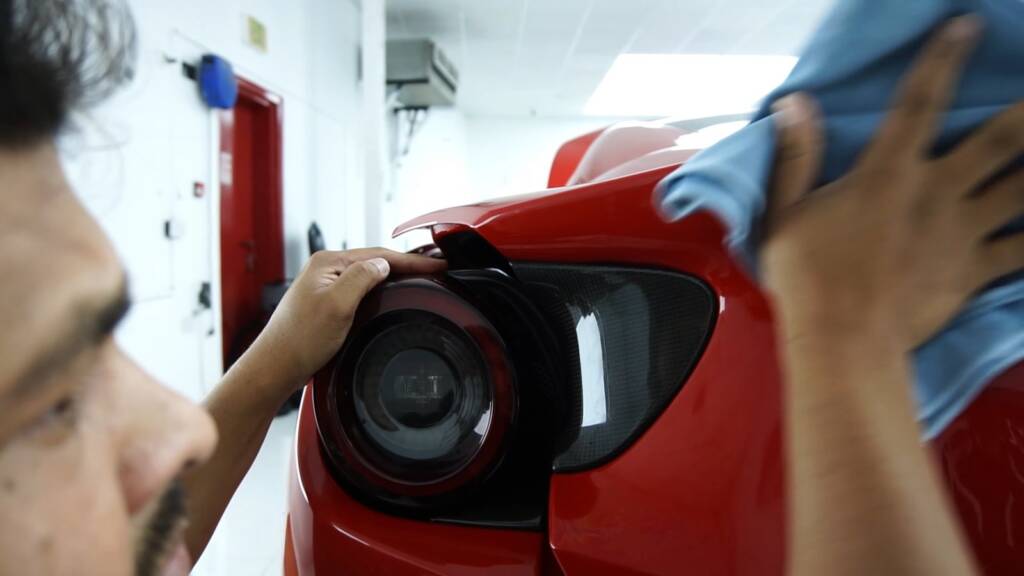 Wiping a Ferrari Portofino headlight after PPF