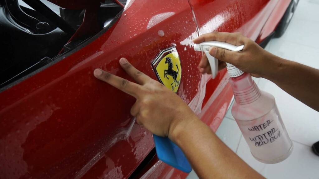 Spraying slip solution at a Ferrari Portofino shield