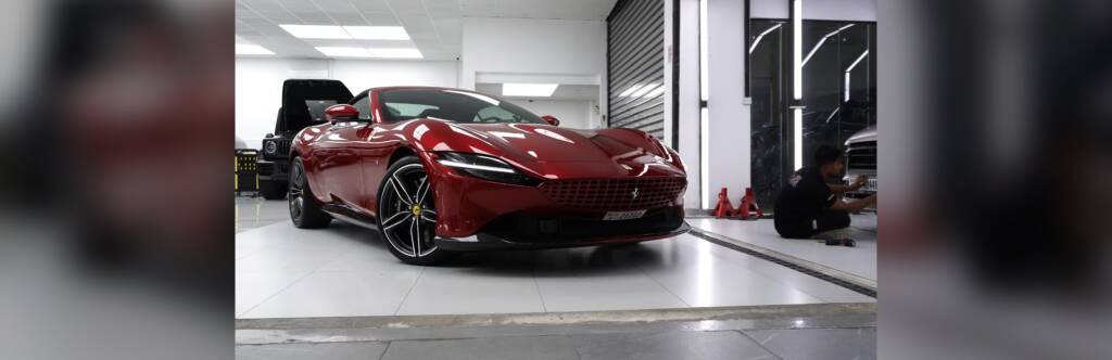Red Ferrari Roma with tinted windows in the Apex studio, Dubai