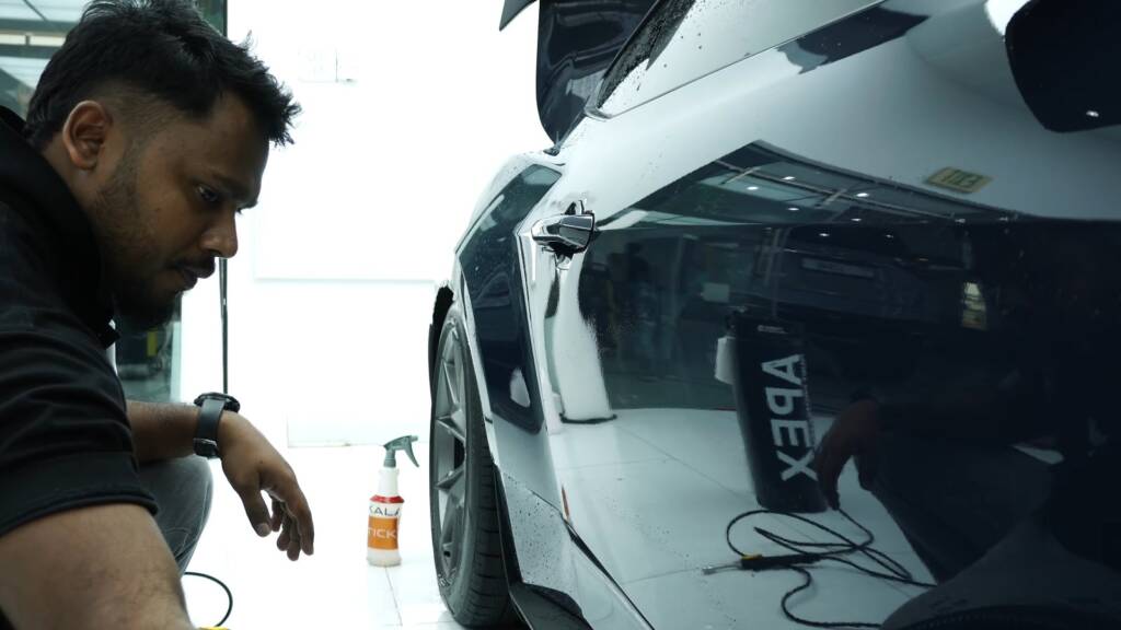 Installer working on the 2024 Ford Mustang Dark Horse door panel at Apex Detail Studio Dubai