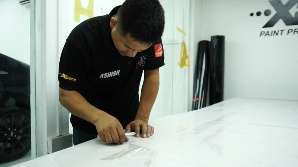 Precut PPF piece for the 2024 Ford Mustang Dark Horse on the table at Apex Detail Studio Dubai