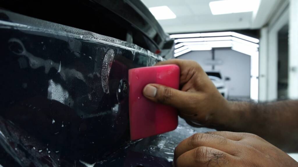 Squeegee on the 2024 Ford Mustang Dark Horse rear panel PPF at Apex Detail Studio Dubai