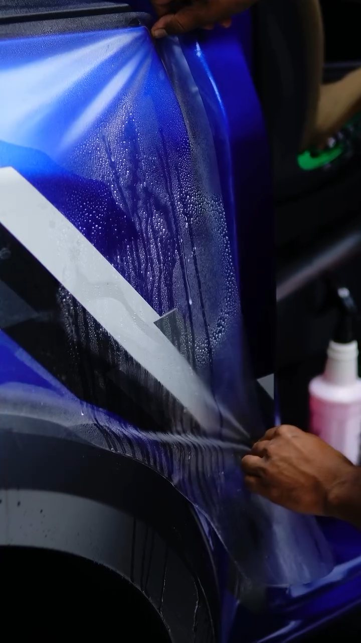 Installer wrapping matte PPF around the Ford Raptor door edge at Apex Detail Studio Dubai