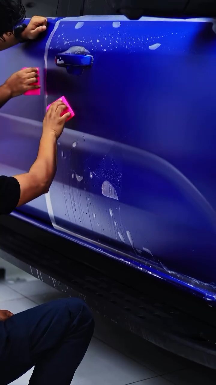 Matte PPF being squeegeed onto the Ford Raptor rear door in Dubai