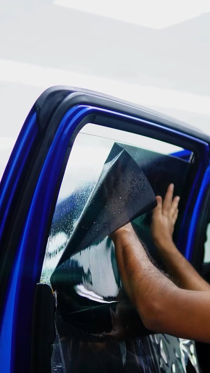 Satin window tint being fitted to the Ford Raptor door glass in Dubai