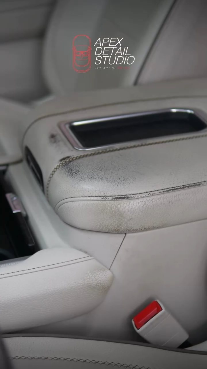 GMC Denali centre console lid with grime before cleaning at Apex Detail Studio