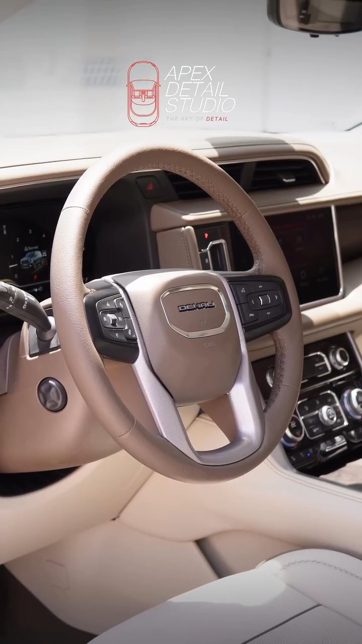 Clean GMC Denali steering wheel and tan leather dash at Apex Detail Studio