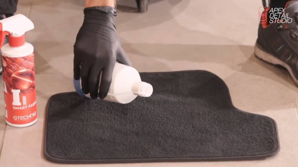 Water poured onto a car floor mat treated with Gtechniq Smart Fabric in Dubai