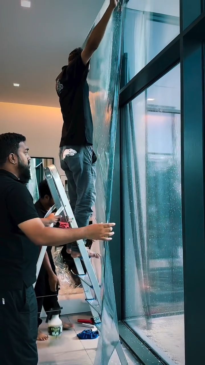 Large glass panel being filmed by the Apex team in a Dubai home