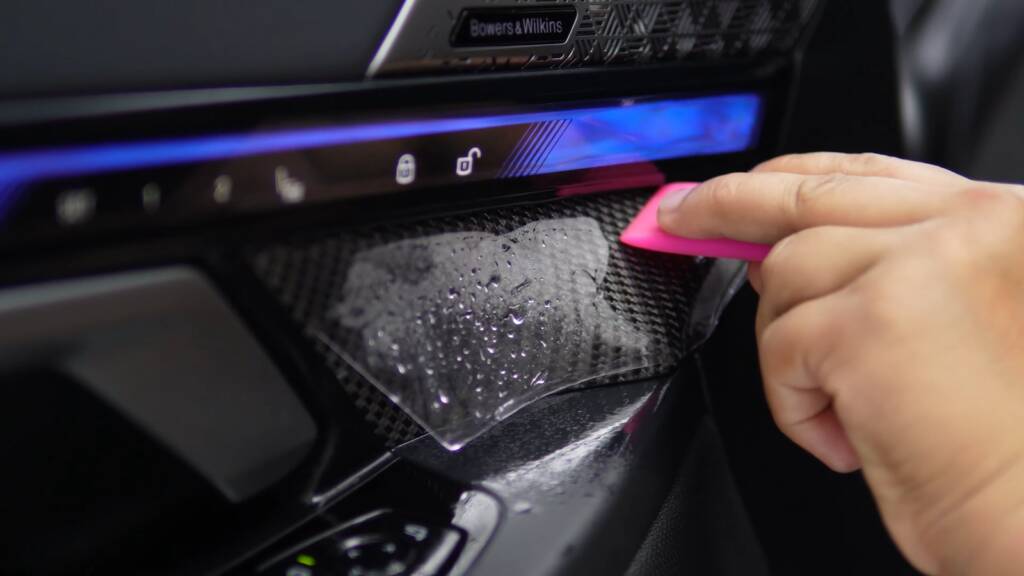 Interior PPF being applied to the dashboard trim of a BMW M5 Touring
