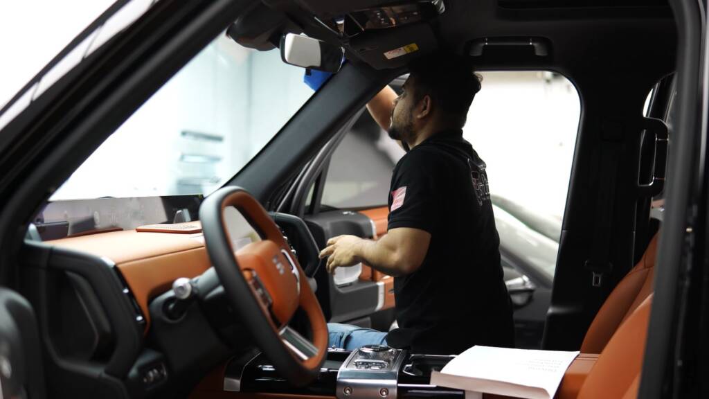 Installer working on Jetour G700 dashboard at Apex Detail Studio
