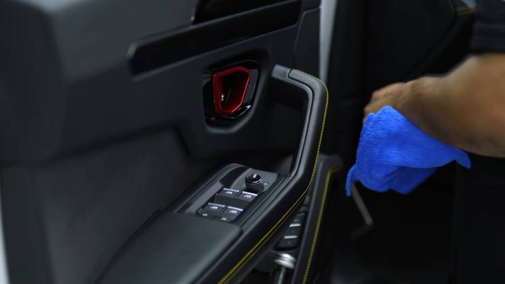 Detailer cleaning the door card of a Lamborghini Urus SE