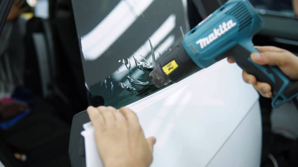 Heat gun helping PPF follow a curve on a Lamborghini Urus SE