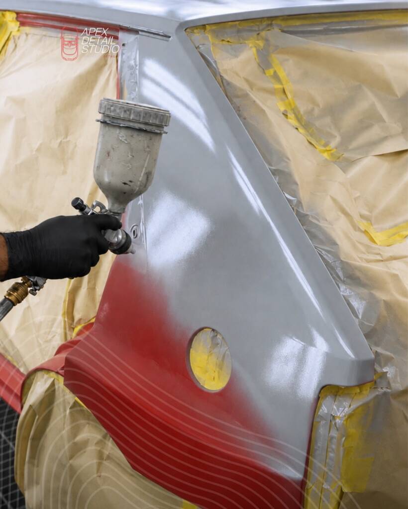 Lancia Delta Integrale rear panel being sprayed grey over red at Apex Detail Studio Dubai