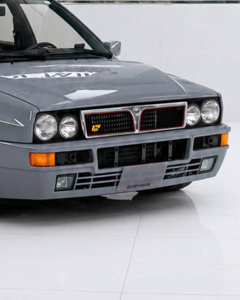 Quad headlights and grille of the Nardo Grey Lancia Delta Integrale at Apex Detail Studio Dubai