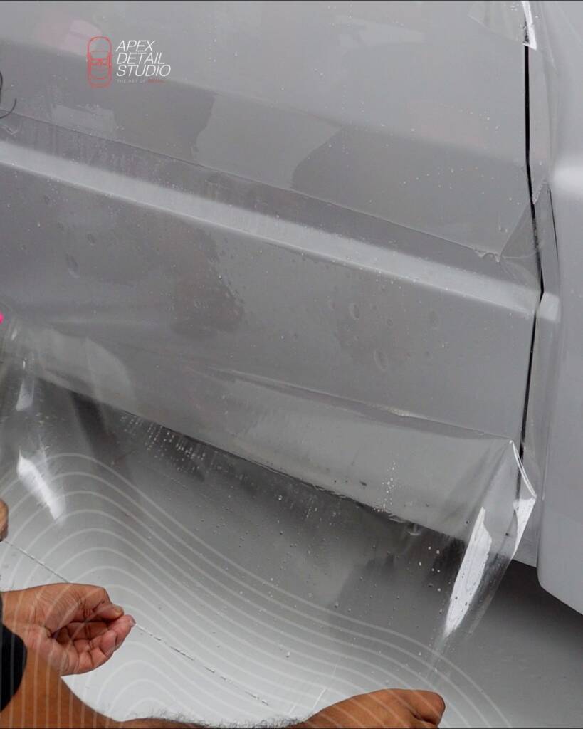 PPF edge being wrapped under the sill of the Lancia Delta Integrale at Apex Detail Studio Dubai